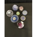 A collection of seven paperweights including four Baccarat style together with a blue Jasperware