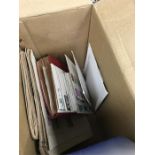 A box containing two albums of stamps plus loose.