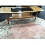 A 1960's style coffee table with glass insert and under shelf