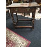 An early oak side table with freize drawer on bobbin turned legs. (21" deep x 31" wide).