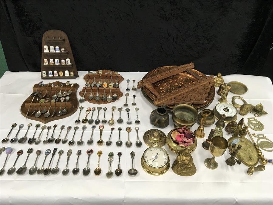 A large collection of thimbles, teaspoons and brass.