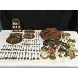 A large collection of thimbles, teaspoons and brass.