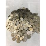 A tub of coins consisting of old silver five pence pieces and other coins.