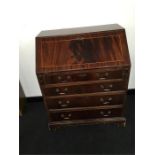 A mid 20th century mahogany bureau with four drawers to front resting on bracket feet