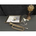 A vintage amber glass lamp together with a picture and a trumpet.