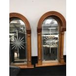 A pair decorative domed mirrors with etched plates and turned columns (59" high x 31" wide).