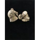 Two Japanese Netsuke one of a young boy with his hands tied behind his back, and a similar old