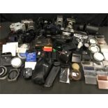 A large quantity of camera equipment and accessories. Approximately 11 cameras, large collection