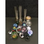 A collection of 14 various glass paperweights together with 5 single stem glass vases.