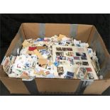 A box of mixed used stamps.