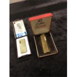 Two boxed cigarette lighters: a Colibri and an Alumode.