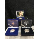 A silver proof Crown together with silver Centenary and Golden Jubilee coins.