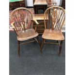 Two 19th century Windsor chairs with elm seats and turned legs one with arms.