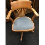 An early 20th century oak office swivel chair with upholstered seat.