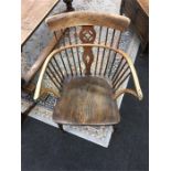 A 19th century comb-back Windsor chair with elm seat and turned legs.