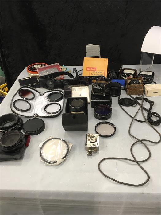 A box of assorted camera equipment, a Leningrada light meter, Aweston light meter ll and lll,