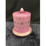 A pink glass cheese stand with lid.