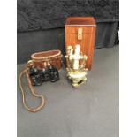 A theodolite with wooden box together with a pair of binoculars in case (no name).