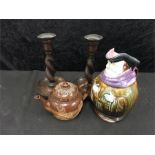 Two wooden candlesticks with a Toby jug and a Doulton Lambeth teapot.