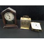 Two mantle clocks together with a wall clock.