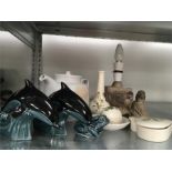 A small collection of Poole Pottery to include two dolphins, a frog, lamp and others.