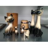 A collection of china cats together with a Wade china tankard and a brown Sadler vase.