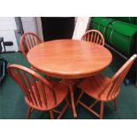 A circular dining table with fold out central leaf together with six chairs. (picture only shows