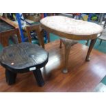 A milking stool together with a kidney shaped stool.