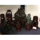 A quantity of resin Buddhas and Chinese dragons.