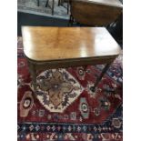 A 19th century mahogany card table with lift over top lined with green baize resting on ring