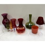A collection of coloured glass vases and bowls.