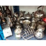 A collection of silver plate items to include tea pots, jugs and toast rack.