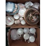 Two boxes containing the residue of various tea sets, plates and glasses.