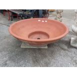 A large circular terracotta planter.