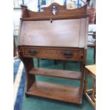 An oak hallway bureau with single drawer under fall flap.