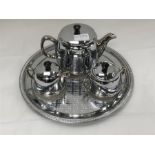 A chrome tea set on tray.