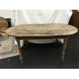 A Victorian pine oval top kitchen table on turned legs.