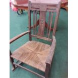 A string seated rocking chair.