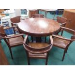 A dining table and six elbow chairs.