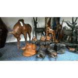 Various wooden African animals together with bird ornaments.