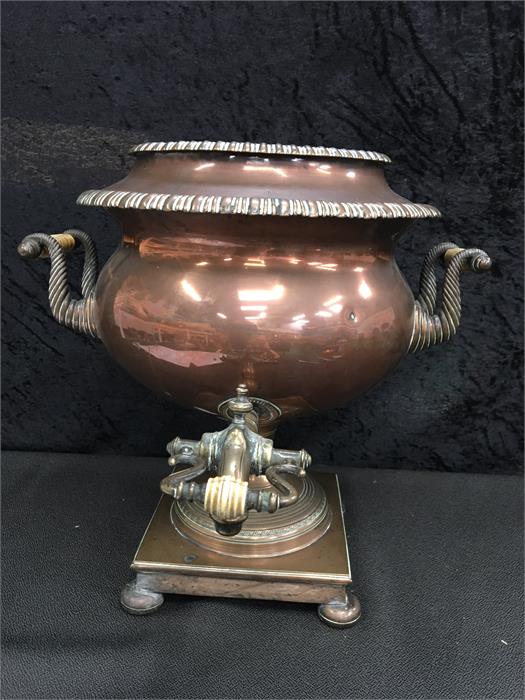 A part copper Samovar with twin handles and a square base with decorative engraving.(13.5" high).