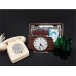 A retro rotary telephone with a retro metamec mantle clock, a Coca Cola advertising mirror and