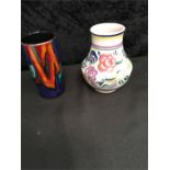 A Poole Pottery 7" vase in the Traditional pattern together with another.