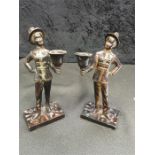 A pair of bronzed candlesticks modelled as Bellboys wearing top hats. (8" high).