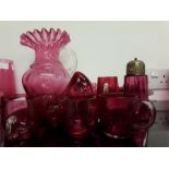 A selection of Cranberry glass to include shakers, jug, sugar bowls etc.
