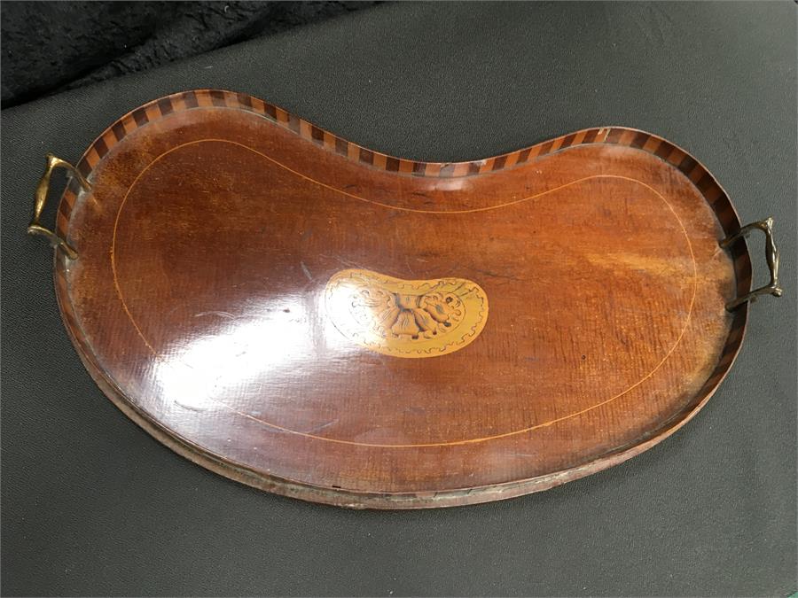 A 19th century mahogany kidney shaped gallery tray with inlay to centre and two brass handles.