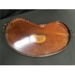 A 19th century mahogany kidney shaped gallery tray with inlay to centre and two brass handles.