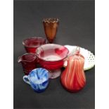 A large selection of various coloured glassware.