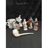 Three figurines after Meissen together with two others, a large clay pipe made for the Crystal