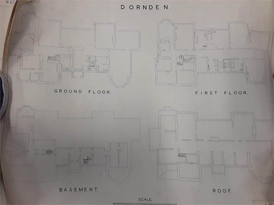 A roll of various paper ephemera and floor plans in a tube.